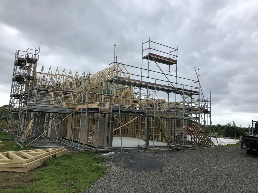 Scaffolding around the timber framing of a house