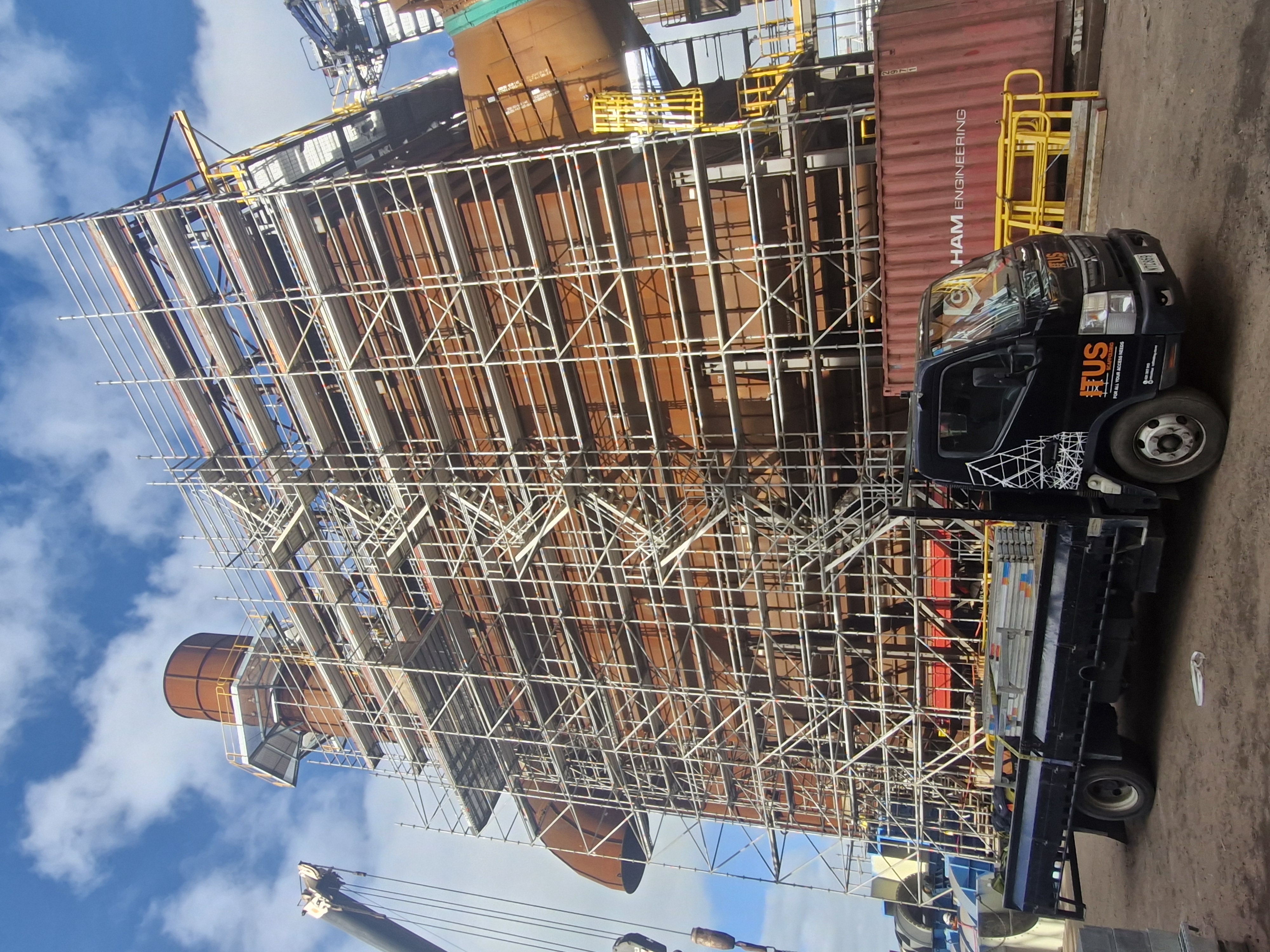 Large commercial scaffold framing around an industrial building